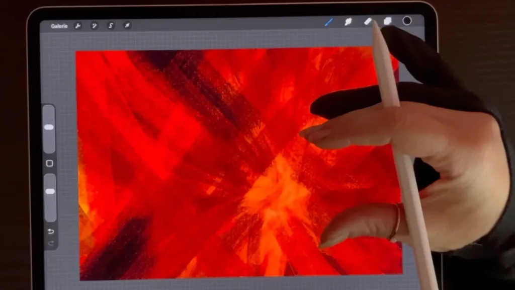 La formatrice Sylvie Roduit montre comment dessiner pour libérer ses émotions avec des traits rouges intenses exprimant la colère sur tablette.