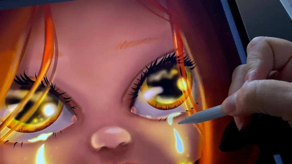 Gros plan sur une main dessinant un œil en pleurs sur une tablette graphique, illustrant le travail de Sylvie Roduit pour dessiner ses émotions.